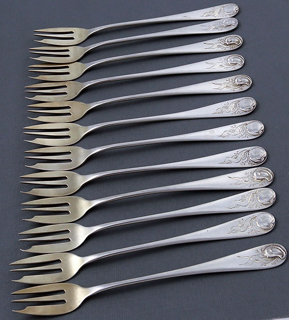 set of twelver sterling oyster forks by Durgin with applied oyster