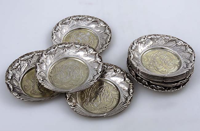 Set of 12 Tiffany ornate butter pats with acid etched monogram