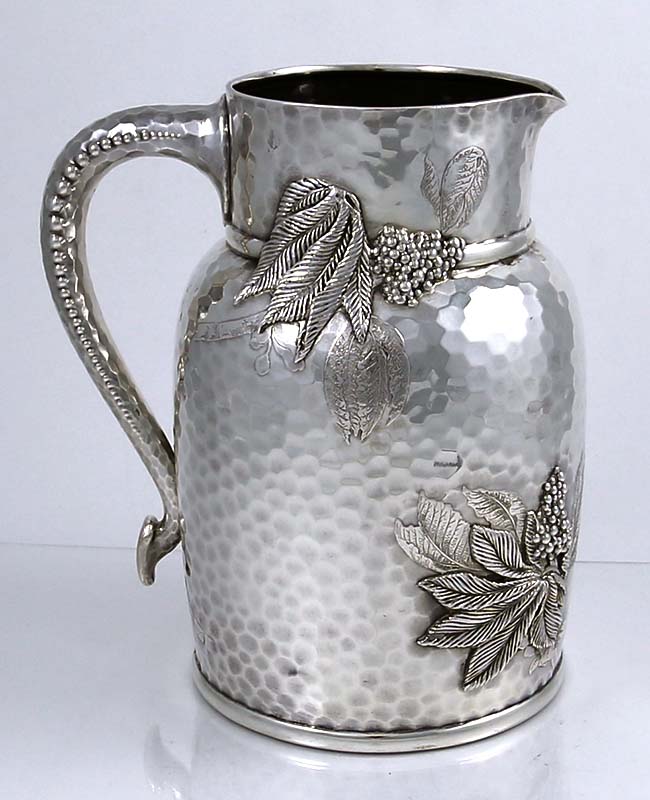 Tiffany hand hammered sterling silver pitcher with acid etched and applied decoration