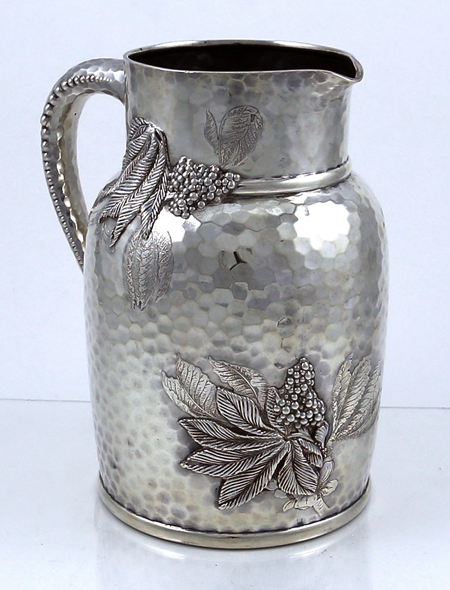 Tiffany hand hammered sterling silver pitcher with acid etched and applied decoration