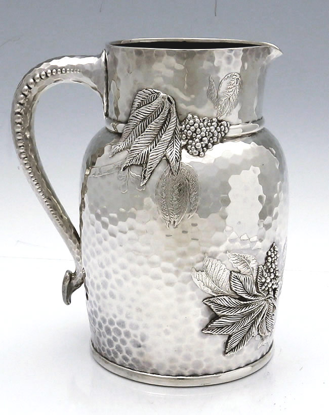 Tiffany hammered sterling water pitcher with chased sumac